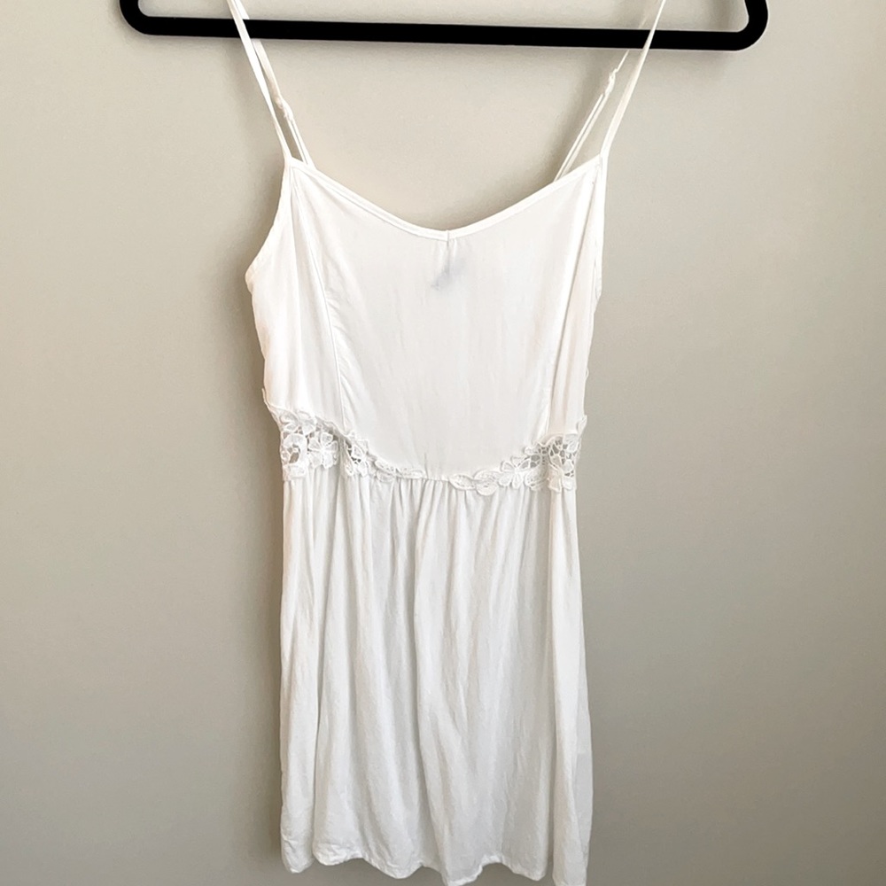 White flowy mini dress with lace cutouts